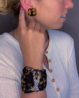 model wearing resin clip earring in tortoise shell