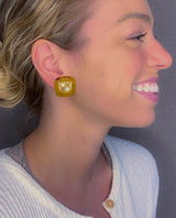 model wearing resin clip earrings in honey