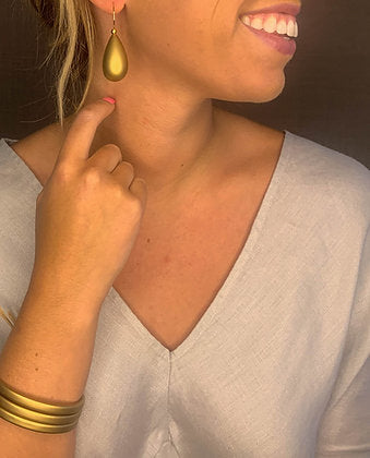 model wearing resin earrings in matte gold