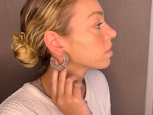 model wearing resin earrings in rose