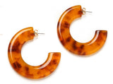 top view of resin earrings in honey