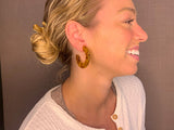 model wearing resin earrings in honey