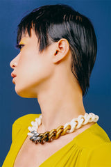 model wearing resin necklace in white