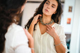 model wearing resin necklace in neutrals