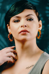 Model wearing resin earrings in honey