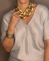 model wearing resin necklace in matte gold