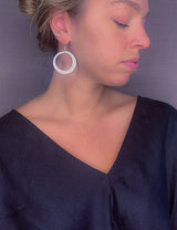 model wearing organic-shaped silver earrings