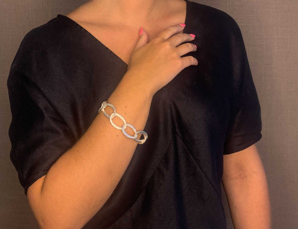 model wearing organic-shaped silver bracelet