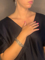 model wearing organic-shaped silver bracelet