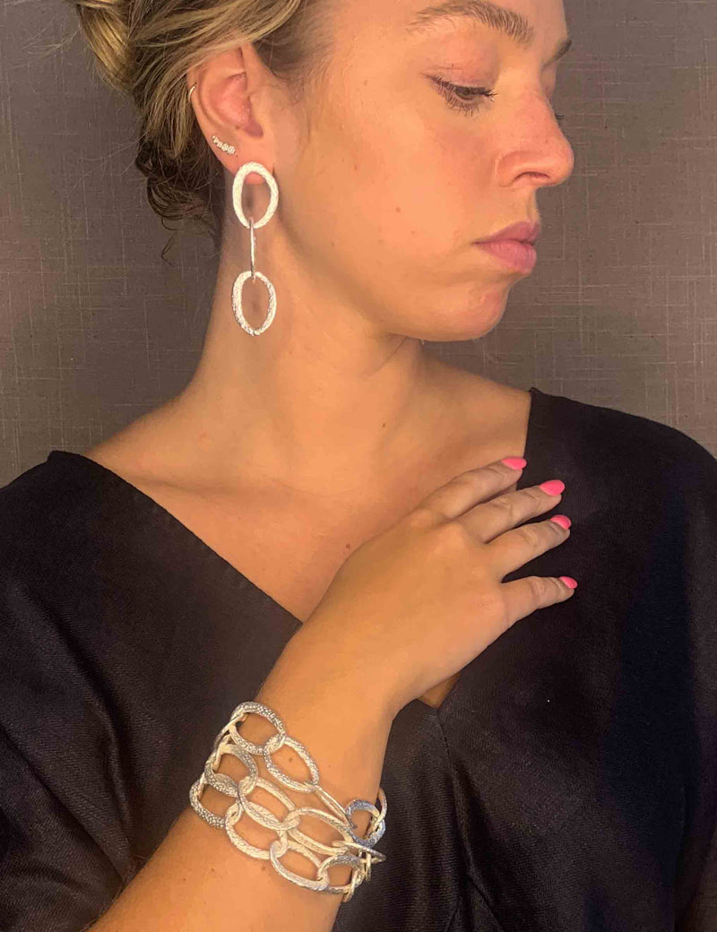 model wearing organic-shaped silver bracelet