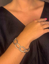 model wearing organic-shaped silver bracelet