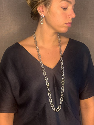 model wearing organic-shaped silver earrings