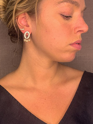 model wearing organic-shaped silver earrings