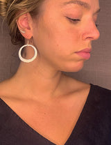 model wearing organic-shaped silver earrings