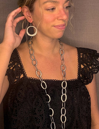 model wearing organic-shaped silver earrings