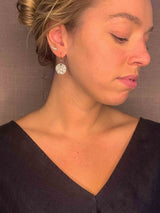 model wearing organic-shaped silver earrings