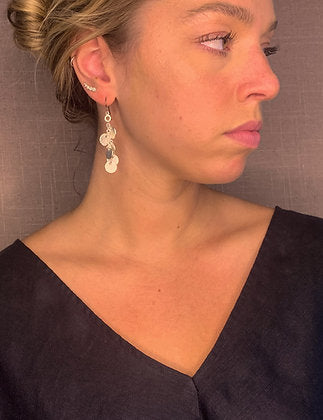 model wearing organic-shaped silver earrings