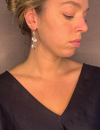 model wearing organic-shaped silver earrings