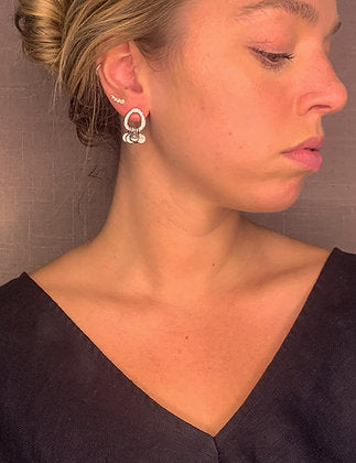 model wearing organic-shaped silver earrings