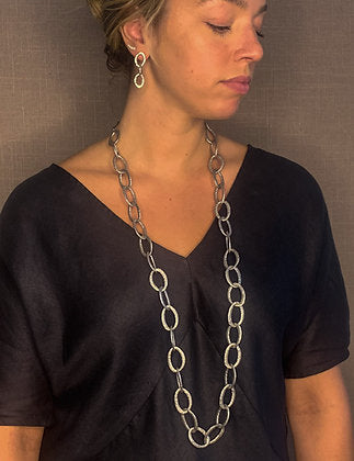 model wearing organic-shaped silver necklace