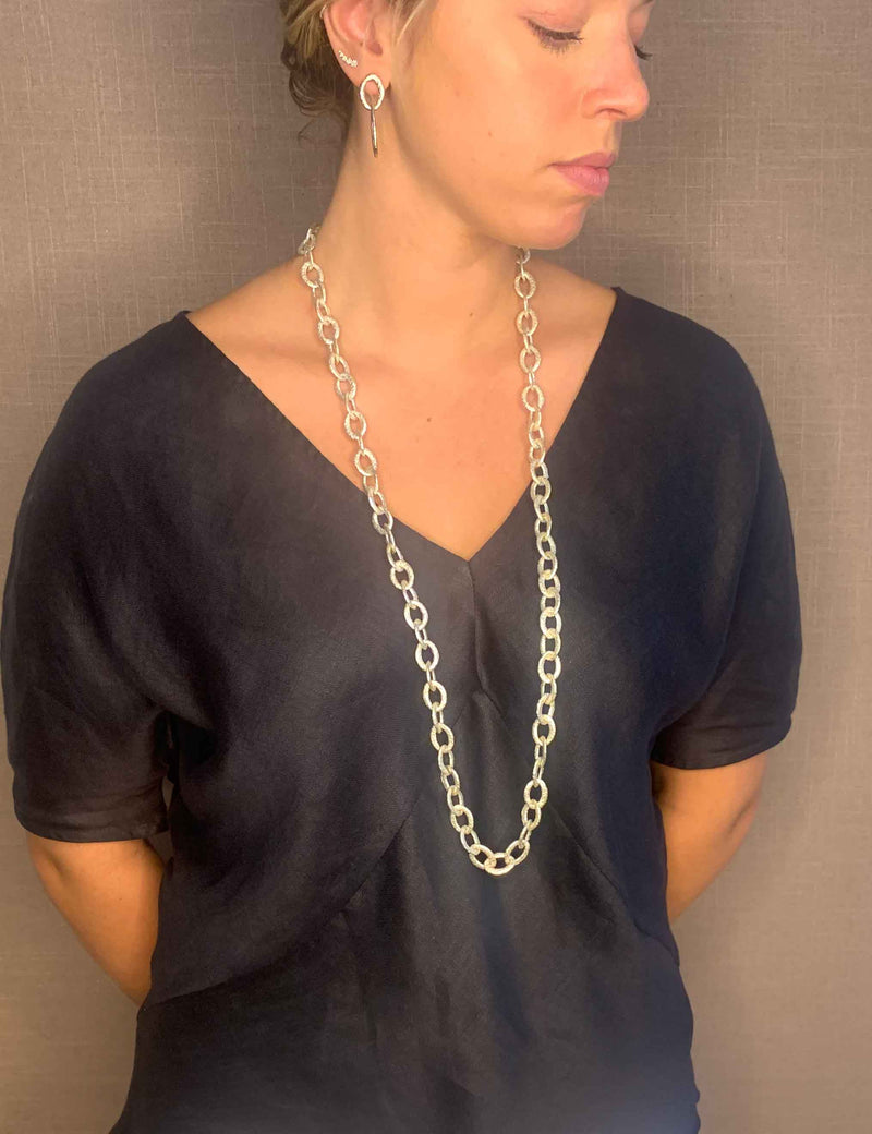 model wearing organic-shaped silver necklace