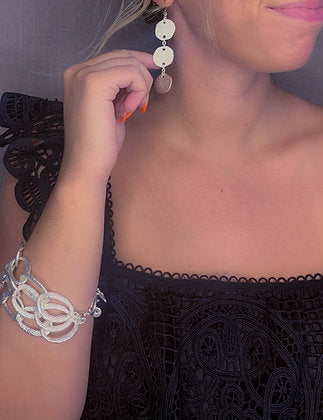 model wearing organic-shaped silver earrings