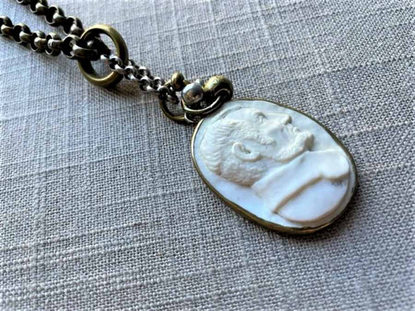 closeup of antique carved Lincoln cameo pendant on chain mix