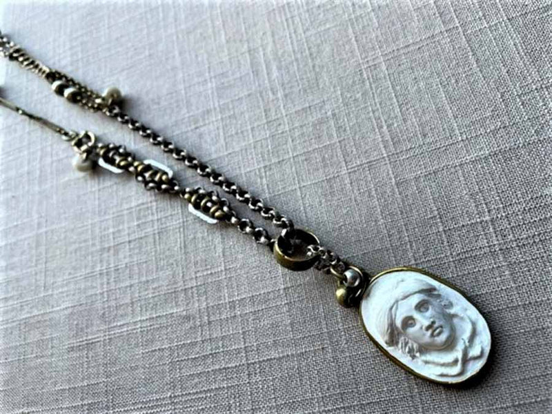 top view of antique carved Medusa cameo pendant on chain mix