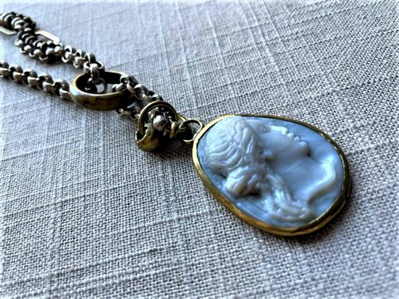 closeup of antique carved Aphrodite cameo pendant on chain mix