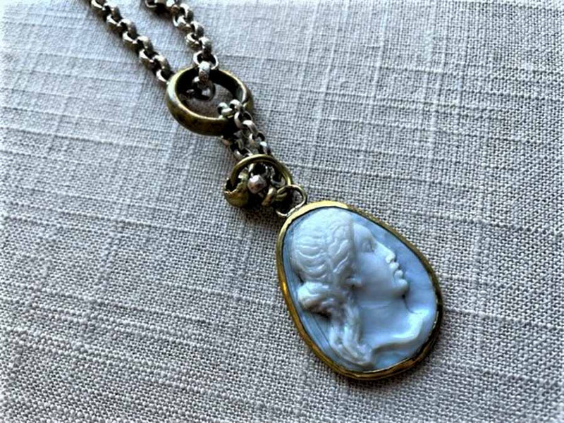 closeup of antique carved Aphrodite cameo pendant on chain mix