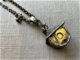 side view of antique salt shaker birdhouse pendant on chain mix