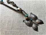 side view  of antique butterfly pendant on chain mix