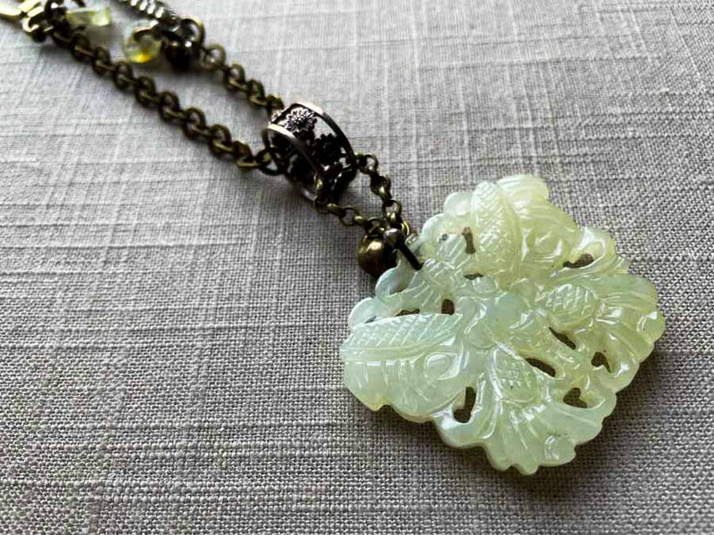 side view of antique jade butterfly pendant on chain mix