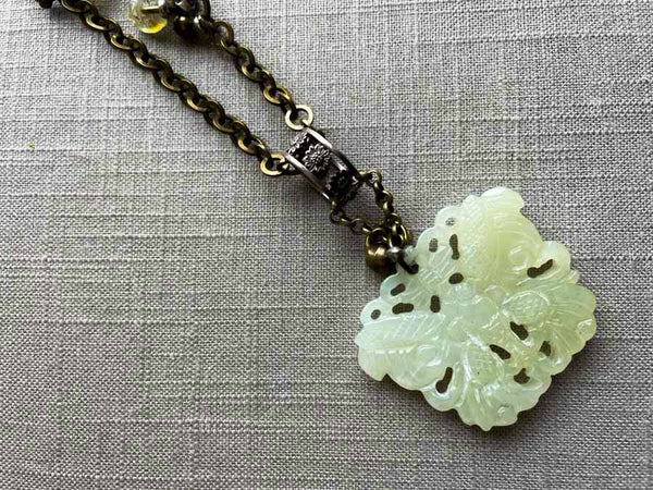 closeup of antique jade butterfly pendant on chain mix