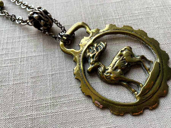 side view of antique bronze stag ornament pendant on chain mix