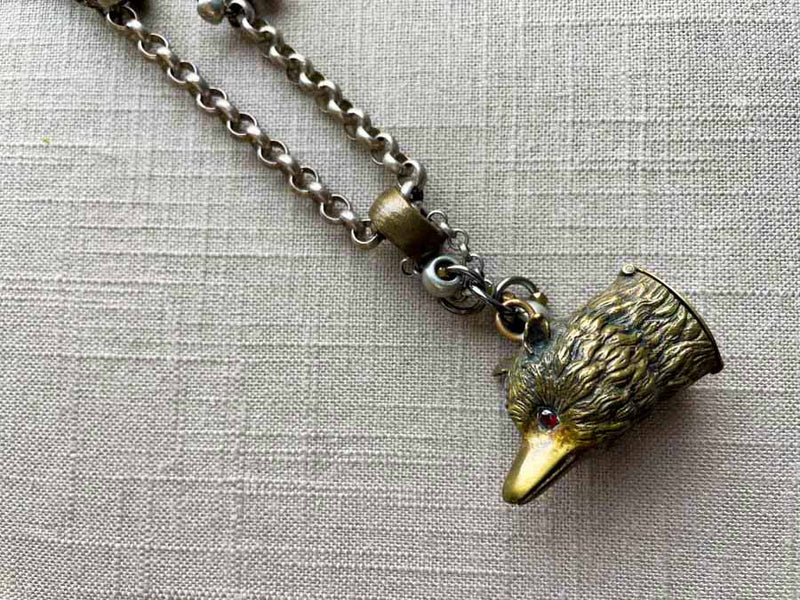 closeup of fox match safe pendant on chain mix