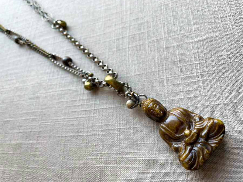 top view of antique carved jade buddha pendant on chain mix