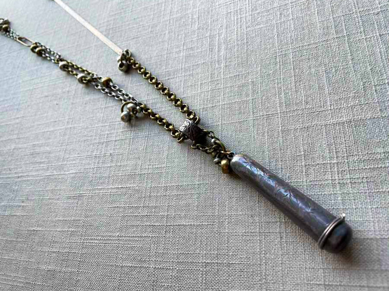 top view of antique sterling silver needle holder on chain mix