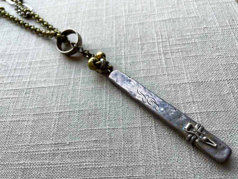 closeup of antique sterling silver pencil holder on chain mix