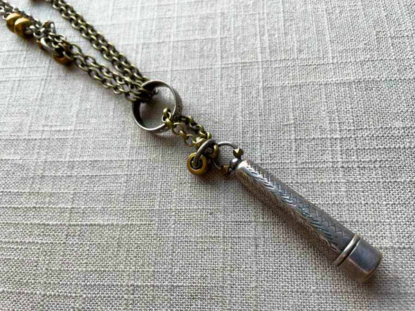 closeup of antique sterling silver telescoping cigarette holder on chain mix