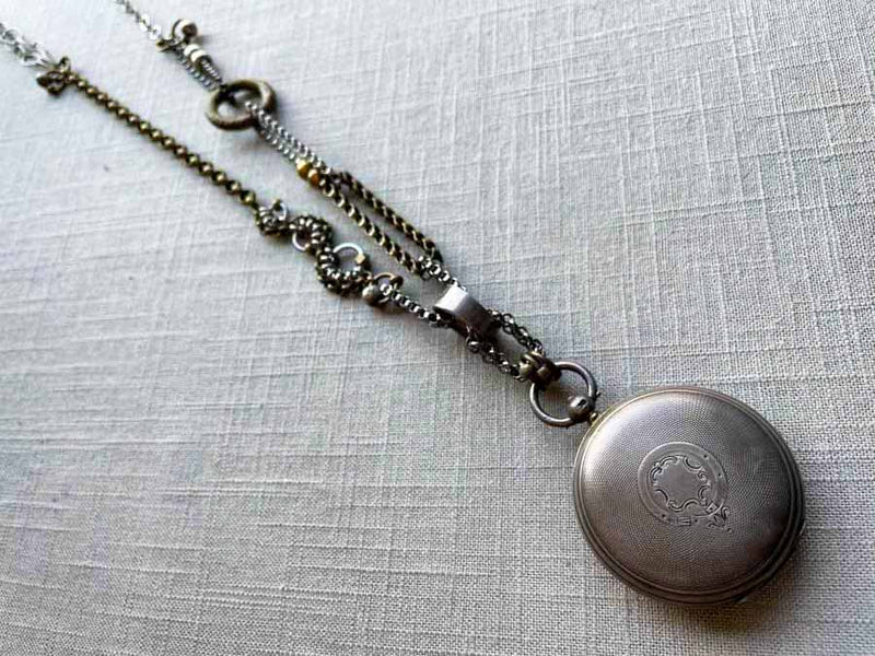 top view of antique sterling silver pocket watch case on chain mix