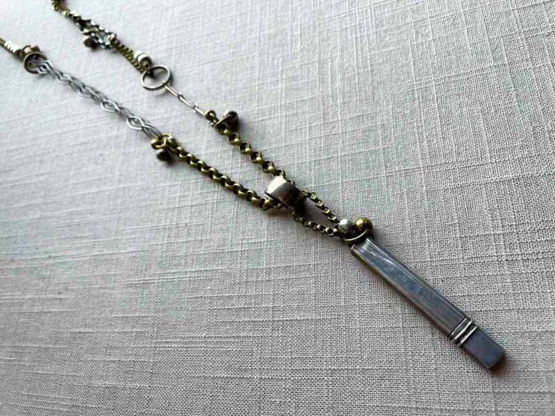 top view of antique sterling silver pencil holder on chain mix