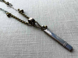 closeup of antique sterling silver pencil holder on chain mix