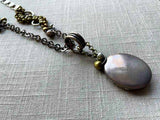 closeup of antique sterling silver locket on chain mix