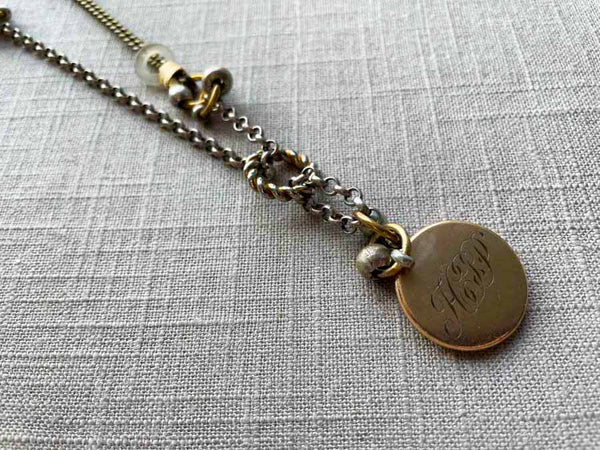 closeup of antique gold-plate locket on chain mix