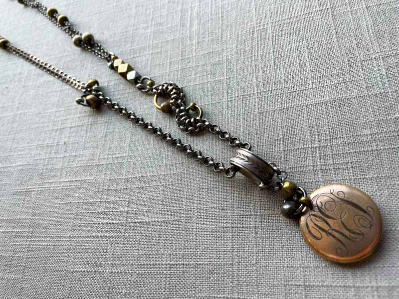 top view of antique gold-plate locket on chain mix