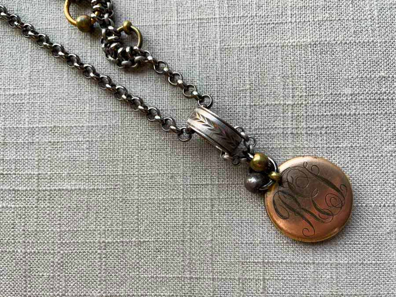 closeup of antique gold-plate locket on chain mix