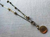 top view of antique gold-plate locket on chain mix