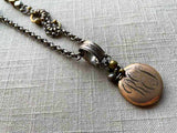 closeup of antique gold-plate locket on chain mix