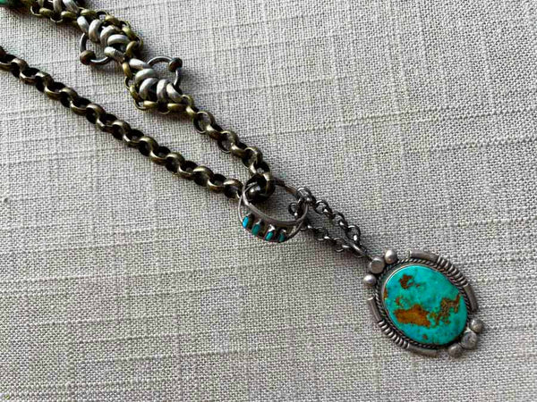 closeup of modern sterling silver turquoise pendant on chain mix